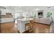 Open-concept kitchen featuring a large island, hardwood floors, and seamless flow to the living area at 12512 Journeys End Trl, Huntersville, NC 28078