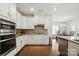 Modern kitchen with stainless steel appliances, and sight lines to the dining area and living room at 12512 Journeys End Trl, Huntersville, NC 28078