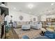 Spacious living room with open floor plan, stone fireplace, comfortable seating, and access to the kitchen at 12512 Journeys End Trl, Huntersville, NC 28078
