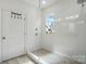 Bright shower featuring subway tile, window, glass door and modern shower head at 12512 Journeys End Trl, Huntersville, NC 28078