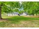 Large backyard with mature trees and a new wooden fence creates a private oasis for outdoor enjoyment at 1252 Spring View Ct, Rock Hill, SC 29732