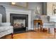 Elegant fireplace with decorative mantel, flanked by armchairs, enhancing the living room's cozy ambiance at 1252 Spring View Ct, Rock Hill, SC 29732