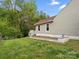 Backyard with a small garden and view of the side of the house at 1280 Willowbreeze Sw Ct, Concord, NC 28025