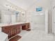 An open bathroom has double sinks, vanity area, TV, and leads into bedroom at 1280 Willowbreeze Sw Ct, Concord, NC 28025