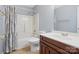 Bathroom with shower/tub combo, wood vanity, and wood-look flooring at 1280 Willowbreeze Sw Ct, Concord, NC 28025