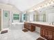 Bright bathroom with soaking tub, double sinks, walk-in shower, and white tile floor at 1280 Willowbreeze Sw Ct, Concord, NC 28025