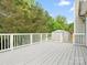 Back porch area with white railings, storage shed, and surrounding trees at 1280 Willowbreeze Sw Ct, Concord, NC 28025