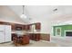Well-lit kitchen with wooden cabinets, island, and white appliances at 1280 Willowbreeze Sw Ct, Concord, NC 28025