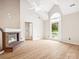 Comfortable living room with a fireplace, vaulted ceiling, and view of the front porch at 1280 Willowbreeze Sw Ct, Concord, NC 28025