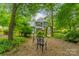 Beautiful backyard with patio chairs, an archway, and views of the home at 14926 Chilgrove Ln, Huntersville, NC 28078