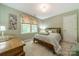 Charming bedroom with green walls, a comfortable queen bed, and a large window bringing in natural light at 14926 Chilgrove Ln, Huntersville, NC 28078