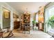 Elegant dining room features a wood table, chandelier, and built-in hutch at 14926 Chilgrove Ln, Huntersville, NC 28078