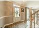 Bright foyer with a wood-look floor, decorative rug, staircase, and front door with glass paneling at 14926 Chilgrove Ln, Huntersville, NC 28078