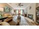 Comfortable living room features a fireplace, ceiling fan, and neutral decor with windows at 14926 Chilgrove Ln, Huntersville, NC 28078