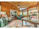 Inviting sunroom with wood paneled walls, cozy seating area, and large windows offering bright, natural light at 14926 Chilgrove Ln, Huntersville, NC 28078