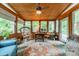 Bright sunroom featuring wood walls, ceiling fan, and multiple windows offering great natural light and views at 14926 Chilgrove Ln, Huntersville, NC 28078