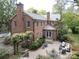 Brick home featuring a brick patio with outdoor seating and lush landscaping at 1943 S Wendover Rd, Charlotte, NC 28211