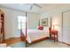 Bright bedroom with wooden floors, light blue rug, and a classic four-poster bed at 1943 S Wendover Rd, Charlotte, NC 28211