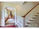 Inviting foyer featuring a curved archway leading to a living room with a window seat and hardwood floors at 1943 S Wendover Rd, Charlotte, NC 28211
