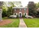 A charming brick home features manicured lawn, crisp landscaping, and classic architectural details at 1943 S Wendover Rd, Charlotte, NC 28211