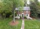 Charming brick home with beautiful landscaping and walkway leading to the front door at 1943 S Wendover Rd, Charlotte, NC 28211