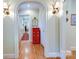 Hallway featuring hardwood floors, archways, and a red dresser at 1943 S Wendover Rd, Charlotte, NC 28211