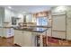Bright kitchen featuring white cabinetry, granite countertops, and stainless steel appliances at 1943 S Wendover Rd, Charlotte, NC 28211