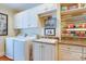Well-equipped laundry area with washer, dryer, built-in storage, and a convenient wrapping paper station at 1943 S Wendover Rd, Charlotte, NC 28211