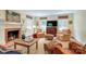 Comfortable living room with a fireplace, TV, patterned armchairs and windows with natural light at 1943 S Wendover Rd, Charlotte, NC 28211
