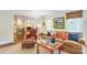 Inviting living room featuring a leather sofa set, hardwood floors, and an open layout with access to kitchen at 1943 S Wendover Rd, Charlotte, NC 28211