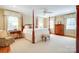 Spacious main bedroom with a four-poster bed, sitting area, and ample natural light at 1943 S Wendover Rd, Charlotte, NC 28211