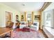 Sitting room with large rug, two white upholstered chairs, and a window seat with curtains at 1943 S Wendover Rd, Charlotte, NC 28211