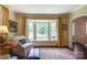 Comfortable sitting room with bay window, window seat, an upholstered chair and oriental rug at 1943 S Wendover Rd, Charlotte, NC 28211