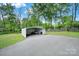 A detached carport with a paved parking area, perfect for protecting vehicles from the elements at 1981 Line Rd, Lancaster, SC 29720