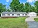 Charming single-story home with a manicured lawn and detached two car garage on a sunny day at 1981 Line Rd, Lancaster, SC 29720