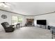 Bright living room with a stone fireplace, comfortable seating, and large windows at 1981 Line Rd, Lancaster, SC 29720