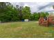 Picture of the spacious, fenced backyard with lush green grass, a storage shed, and a wooden deck at 1990 Country Club Dr, Lancaster, SC 29720