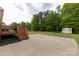 Expansive backyard featuring a concrete patio, a wooden deck, and a storage shed, providing ample outdoor space at 1990 Country Club Dr, Lancaster, SC 29720