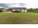Rear view of the home, showcasing a spacious yard and deck, perfect for outdoor entertaining and relaxation at 1990 Country Club Dr, Lancaster, SC 29720