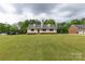 Inviting yellow house with a charming front porch and a large, well-maintained front yard at 1990 Country Club Dr, Lancaster, SC 29720