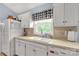 Charming kitchen with white cabinets, white appliances, and a window over the sink at 1990 Country Club Dr, Lancaster, SC 29720