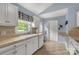 Bright kitchen with white cabinets, tile countertops, and a window providing natural light at 1990 Country Club Dr, Lancaster, SC 29720