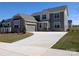 Beautiful two-story home with a stone facade, attached garage, and a long driveway at 2084 Fordhill St, Rock Hill, SC 29732