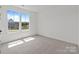 Bright, empty bedroom with a large window offering outdoor views at 210 Goldenrod Cir, Salisbury, NC 28147