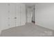 A bedroom with a double door closet and neutral carpet at 210 Goldenrod Cir, Salisbury, NC 28147