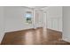 A bedroom featuring hardwood floors, white walls, a large window, and white trim at 210 Goldenrod Cir, Salisbury, NC 28147