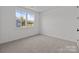 Bright bedroom with neutral carpet and a large window offering a pleasant outdoor view at 210 Goldenrod Cir, Salisbury, NC 28147