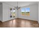 Dining room with french doors, window, hardwood floors, and modern lighting at 210 Goldenrod Cir, Salisbury, NC 28147