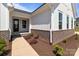 Exterior view of a home with white siding, brick accents, a well-manicured lawn and a concrete walkway at 210 Goldenrod Cir, Salisbury, NC 28147