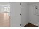 Hallway looking into kitchen and living room, featuring hardwood floors and a laundry room at 210 Goldenrod Cir, Salisbury, NC 28147